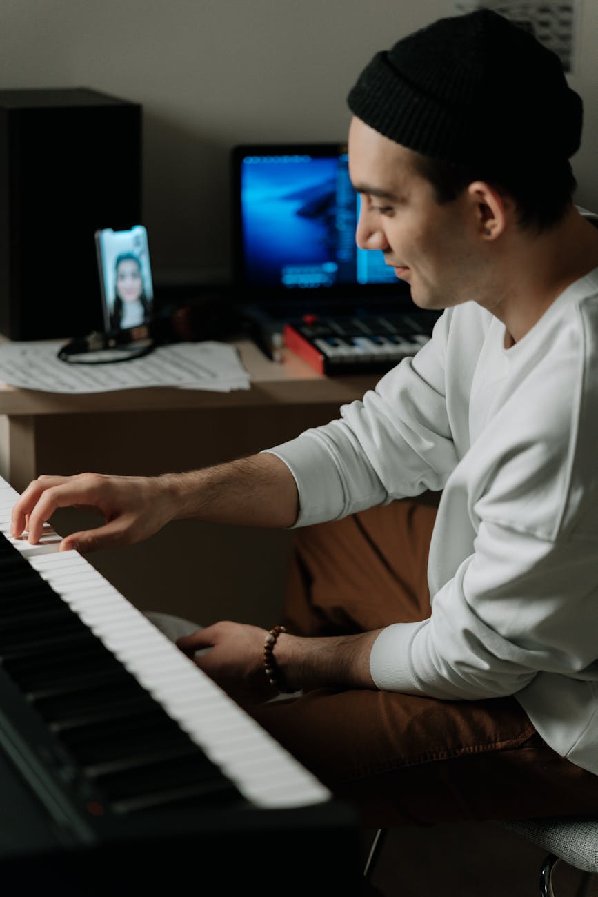 a man in white sleeves playing piano